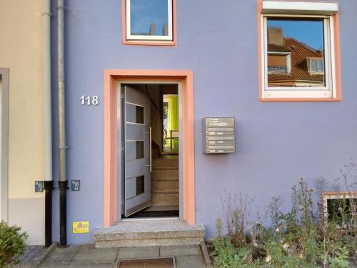 a blue building with a door and stairs at Unique 118 in Bremen