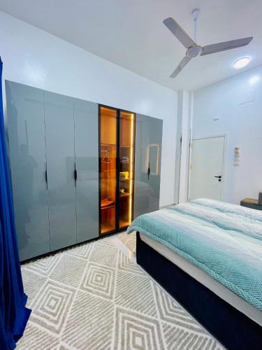 a bedroom with a bed and a ceiling fan at Quiet Villa in Luxor