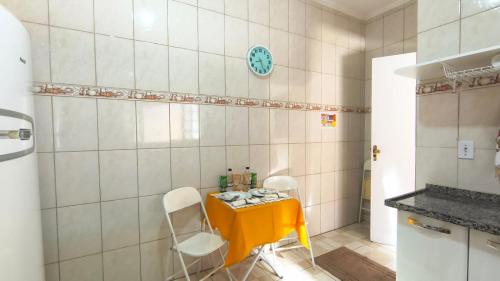 een keuken met een gele tafel en 2 stoelen bij Doce Recanto da re in Franca