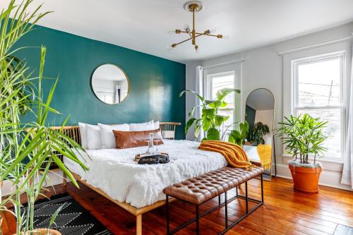 a bedroom with a bed and a couch and plants at Downtown Columbus & Short North 2BR Home - Sleeps up to 10 Guests - By Convention Center & Nationwide Arena - Free Parking - Over 5,800 Five Star Stays - Casita Verde by Jungle House in Columbus
