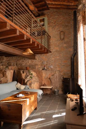 a bedroom with a bed and a staircase in a room at La Casita del Cinglo in Obispo Hernández