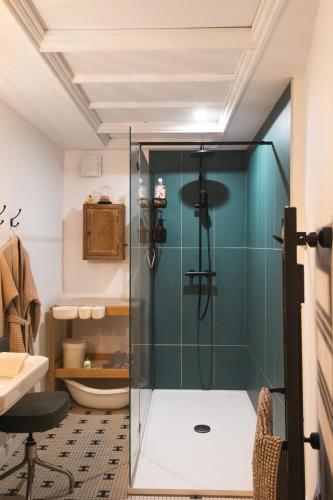 a bathroom with a shower with a glass door at Maison d'hôtes La bien-Aimée in Montrevault