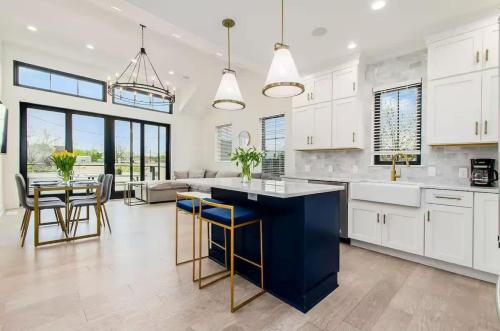 a kitchen with white cabinets and a blue island at Jungle House Luxury Homes - Columbus Downtown Short North - Near Convention Center & Nationwide Arena - Sleeps up to 16 - Free Parking - Over 5,800 Five Stars in Columbus