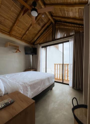 a bedroom with a bed and a large window at Narea San Bartolo in San Bartolo