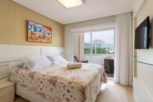 Ένα ή περισσότερα κρεβάτια σε δωμάτιο στο Cobertura com jacuzzi 2 minutos da praia