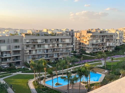 an aerial view of a resort with palm trees and buildings at VESTA - New Cairo Residence in New cairo