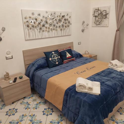 a bedroom with two beds with blue sheets and towels at Casa Emar in Massa Lubrense