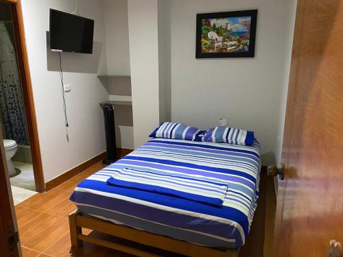 Ένα ή περισσότερα κρεβάτια σε δωμάτιο στο Guesthouse Mancora Hotel