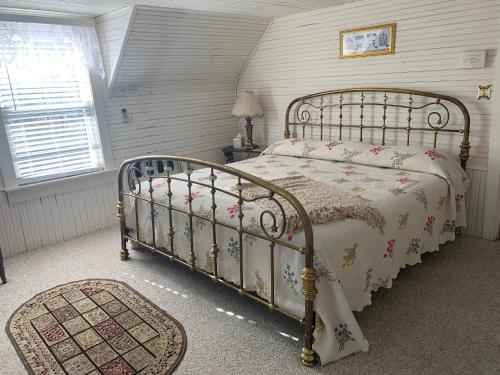 a bedroom with a bed in a room with a window at Mountain Harbour B&B in Roan Mountain
