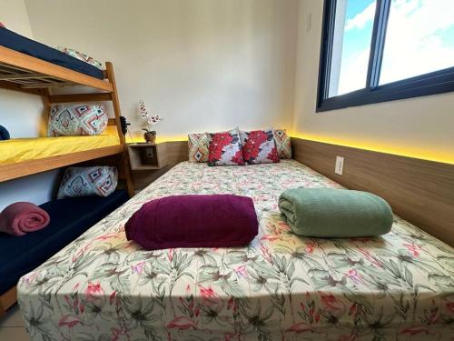 a bed with two pillows on it in a bedroom at TESLA APT2-Pool, Air, gym, 24-hour portaria in São Carlos