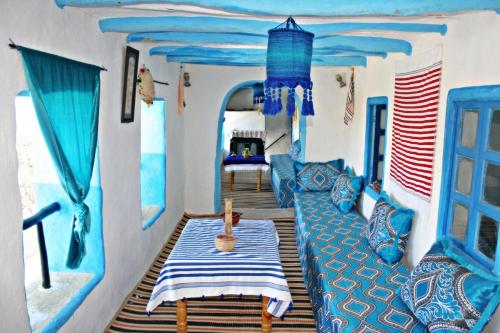 a room with a couch and a table on a boat at Dar Nefzi in Ouazzane