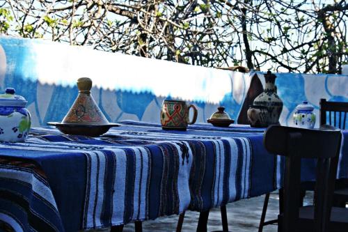 a blue and white table with vases on it at Dar Nefzi in Ouazzane