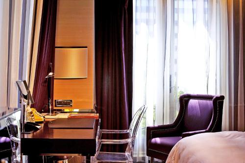 a bedroom with a desk and a bed and a chair at Hotel Eclat Taipei in Taipei