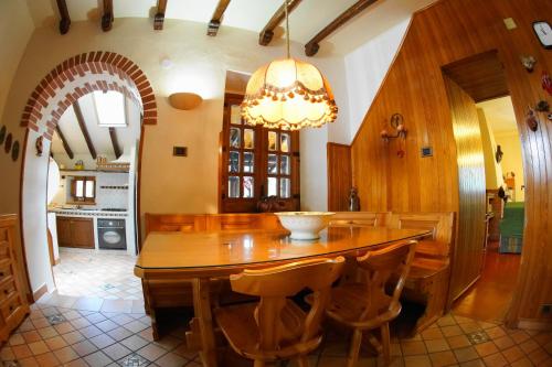 a large dining room with a wooden table and chairs at Etna Paradise locazioni brevi in Ragalna