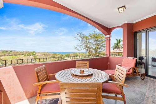 a dining room with a table and chairs on a balcony at Recently Renovated Luxury Condo with Resort-Style Beach Club Access and Ocean Views in Playa Conchal