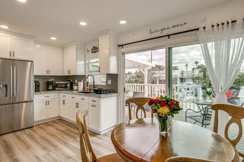 a kitchen with a table with a vase of flowers on it at Breeze by the Marina Chula Vista Getaway! in Chula Vista