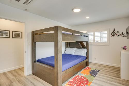 a bedroom with a bunk bed with purple sheets at Breeze by the Marina Chula Vista Getaway! in Chula Vista