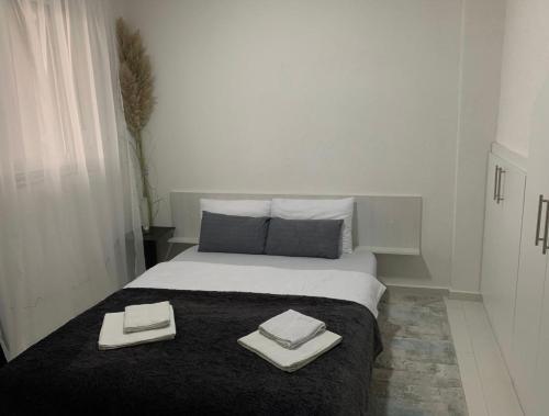 a bedroom with a bed with two towels on it at Aura in Kumanovo