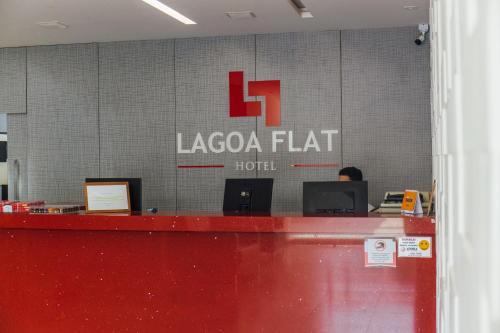 a laocoaga flat hotel sign on a wall in an office at Lagoa Flat Hotel in Lagoa da Prata