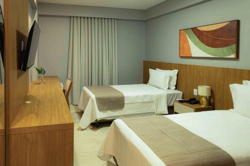 Ένα ή περισσότερα κρεβάτια σε δωμάτιο στο Bristol Castanhal Hotel