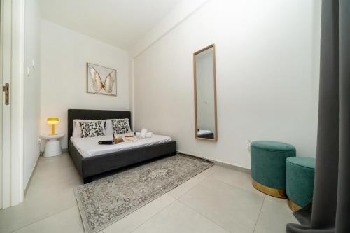a white room with a bed and a mirror at Central 2 bedroom flat in Nicosia
