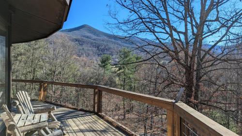 a deck with two chairs and a view of a mountain at The Round House Views for Days! in Luray