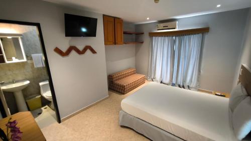 Ένα ή περισσότερα κρεβάτια σε δωμάτιο στο Hotel Parguito