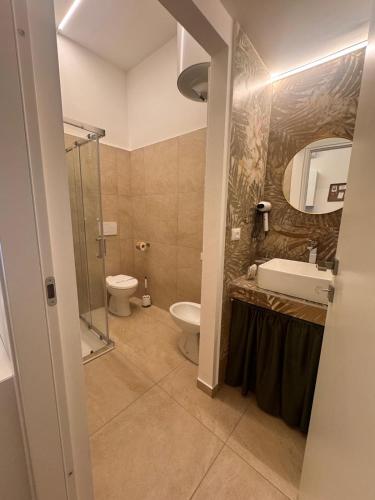 a bathroom with a toilet and a sink and a shower at Villatico 25 in Chiari