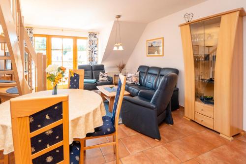 a living room with a table and a couch at Ferienpark Freesenbruch Wohnung 3 5 - Muschelsucher in Zingst
