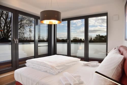 een slaapkamer met een wit bed en een groot raam bij Logierhaus Friedrich WE 24 - "Sandläufer" in Zingst