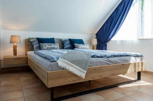 青斯特Residenz am Strand Wohnung 6-80的一间卧室，配有一张带蓝色枕头的床和一扇窗户