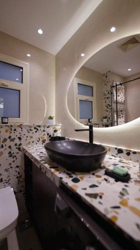 a bathroom with a large black bowl sink on a counter at Mountain View i city October in 6th Of October