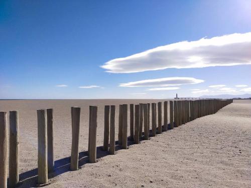a long pier on the beach with a cloudy sky at Villa piscine privée superbe Vue Etang Leucate 8JBART580 in Port Leucate