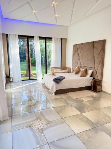 a bedroom with a bed and a tiled floor at Villa Five Collection - Private Luxury & Heated Pool in Ouled Moumene