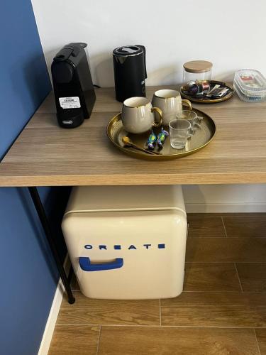 a coffee maker and two cups on a table at KJ guesthouse in Appiano Gentile