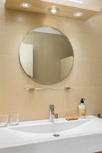 a bathroom sink with a large mirror above it at Oasis guesthouse, Boutique Style Hotel in Kralendijk