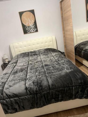 a bedroom with a bed and a mirror at Vista Mare Maisonette in Ipsos