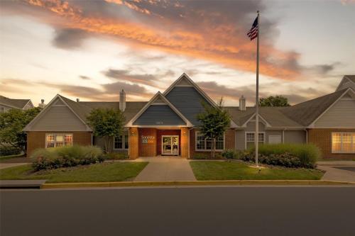 a house with an american flag in front of it at Sonesta ES Suites Fairfax Fair Lakes in Fairfax