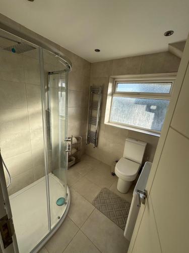 a bathroom with a shower and a toilet at Livs cozy corner in Crossens