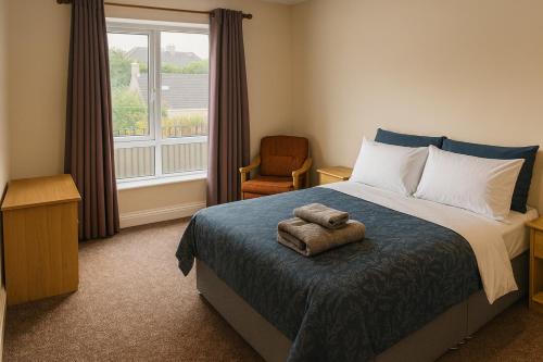 a bedroom with a bed and a chair and a window at Quiet 2-Bed Suburb Stay, Free Parking & Near City in Cork