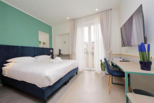 a bedroom with a bed and a desk with a computer at Proja Housing Romagnosi20 in Rome