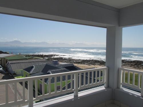 a balcony with a view of the ocean at Point Village Accommodation - Stephen in Mossel Bay