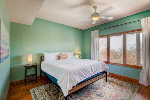 a bedroom with a bed with green walls and a window at Hill Station in Beech Mountain