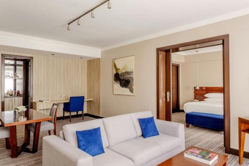 a living room with a couch and a bed at Marriott Hotel Buenos Aires Ezeiza Airport in Ezeiza