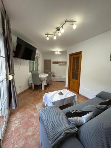 ein Wohnzimmer mit Sofa und Fernseher in der Unterkunft Casa Alegría in Cómpeta