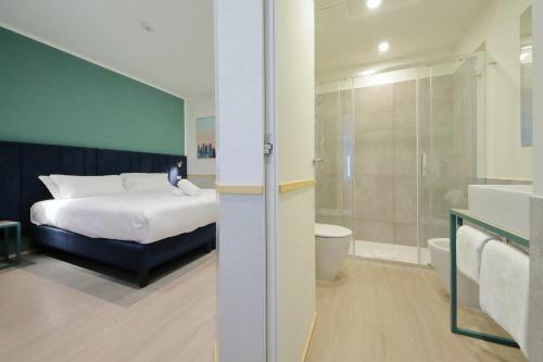 a bedroom with a bed and a bathroom with a shower at Proja Housing Romagnosi20 in Rome