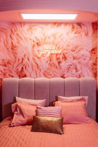 a bedroom with a bed with a faux fur wall at The Rozette Experience in Ostend