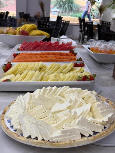 a table topped with different types of food on plates at Thermas de Olimpia Resort in Olímpia