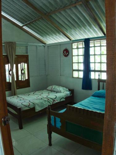 a bedroom with two beds in a room at Coco Encantado Eco Hostal Camping in Cartagena de Indias
