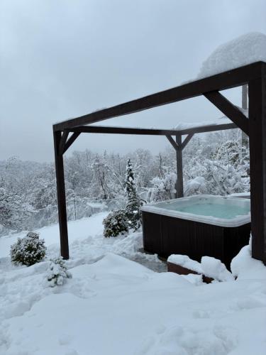 a hot tub in a gazebo covered in snow at Forrest House in Doboj